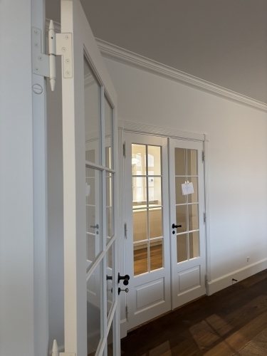 Tømrer udfører udskiftning af dobbelt glasdør mellem stue og opholdsrum